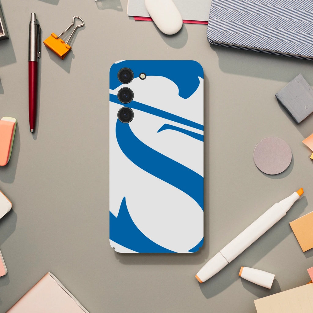 Phone case with blue and white design on a desk with office supplies